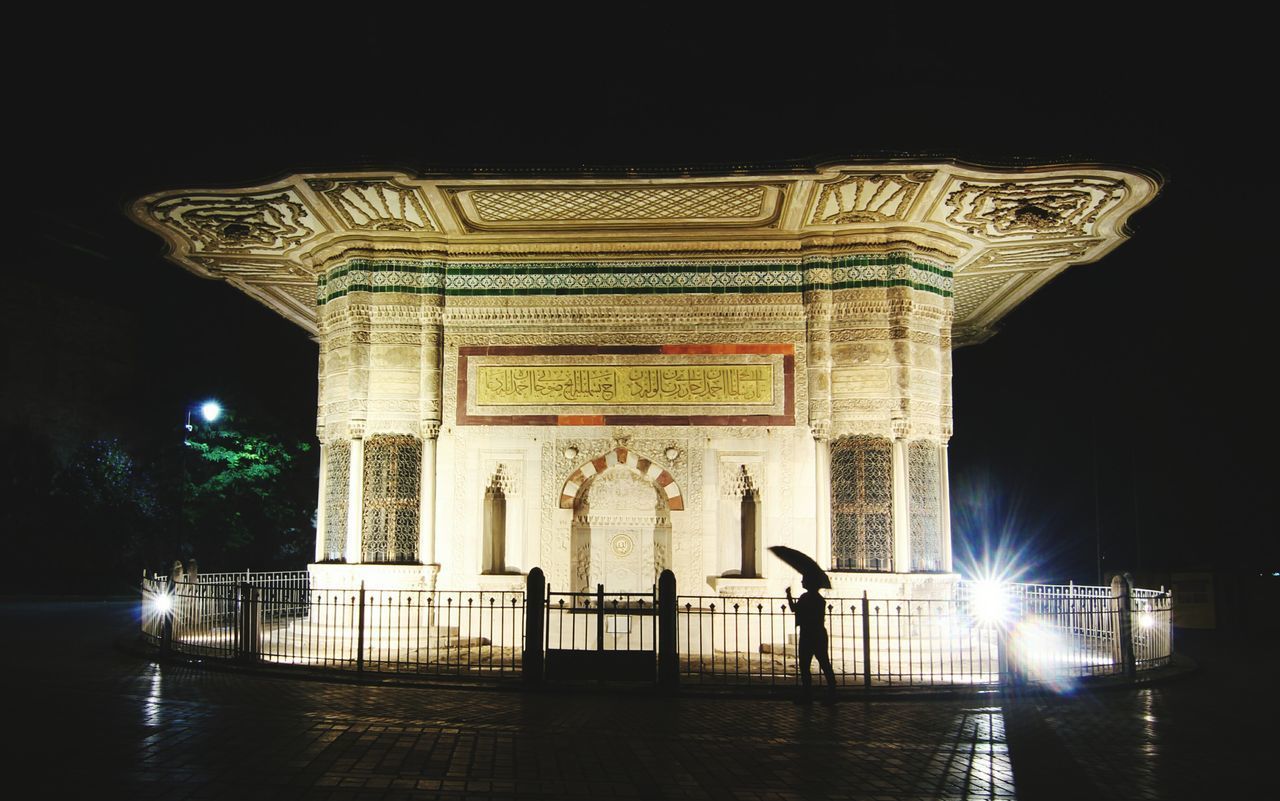 VIEW OF ILLUMINATED BUILDING AT NIGHT