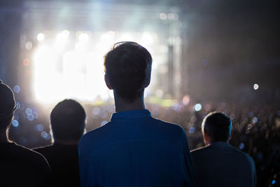 Rear view of people enjoying at music concert