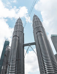 Low angle view of buildings against cloudy sky