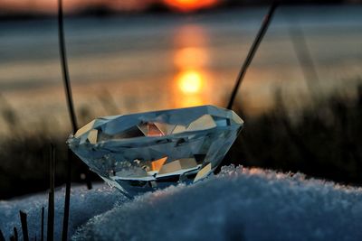 Close-up of diamond on snow during sunset