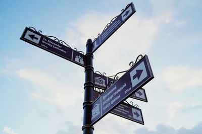 Low angle view of road sign against sky