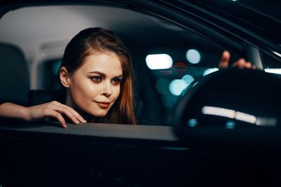 Young woman sitting in car