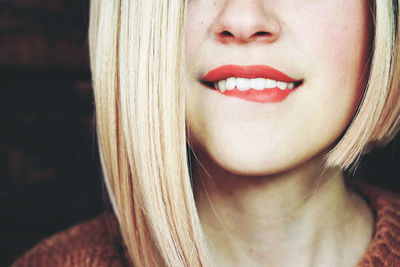 Close-up of smiling young woman with blond hair