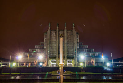 Illuminated building against sky at night