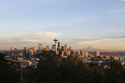 View of buildings in city against cloudy sky