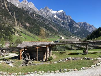 Scenic view of field and mountains against sky