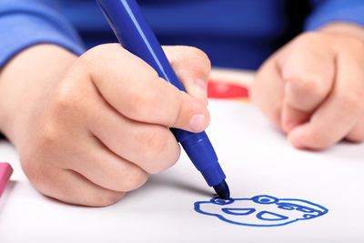 Cropped hand of person drawing on paper