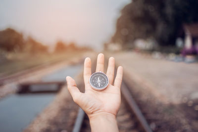 Close-up of hand holding navigational compass