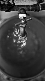 High angle view of water pouring from faucet