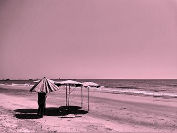 Lifeguard chair on beach against clear sky