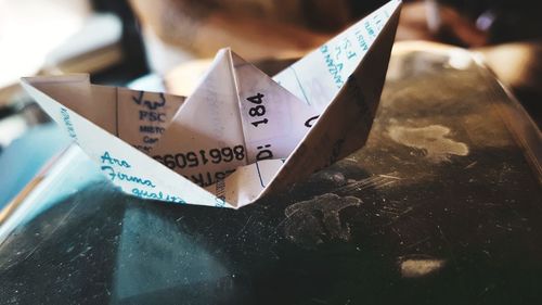 Close-up of paper boat on table