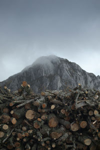 Stack of rocks on mountain against sky