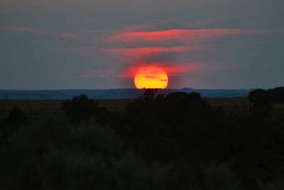 Scenic view of silhouette land against sky at sunset