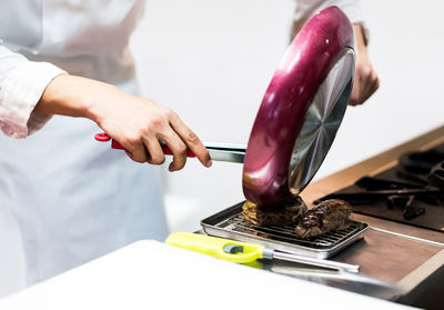 Midsection of man using sewing machine