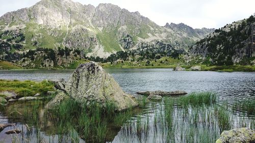 Scenic view of lake and mountains against sky