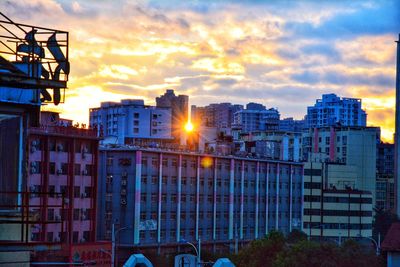 Buildings against sky at sunset