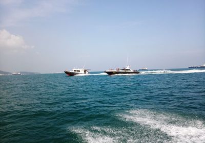 Boats in sea against sky