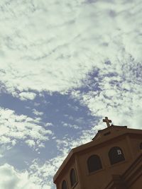 Low angle view of building against cloudy sky