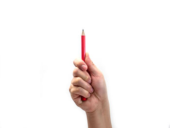 Close-up of woman holding hands over white background