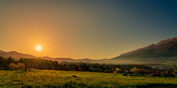 Scenic view of field against sky during sunset