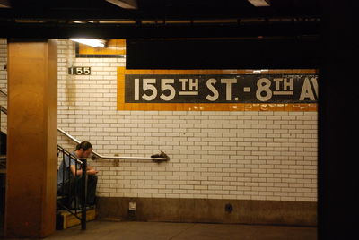 Rear view of man standing at subway station