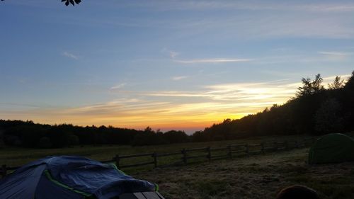 Scenic view of field against cloudy sky