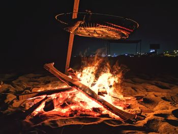 Bonfire by fire at night