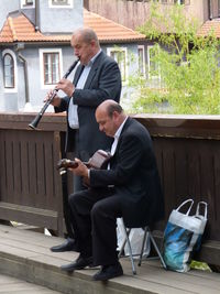 Full length of man sitting at camera