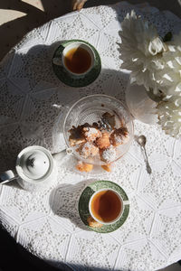 English style tea break, still life with flowers and donuts in the morning sun