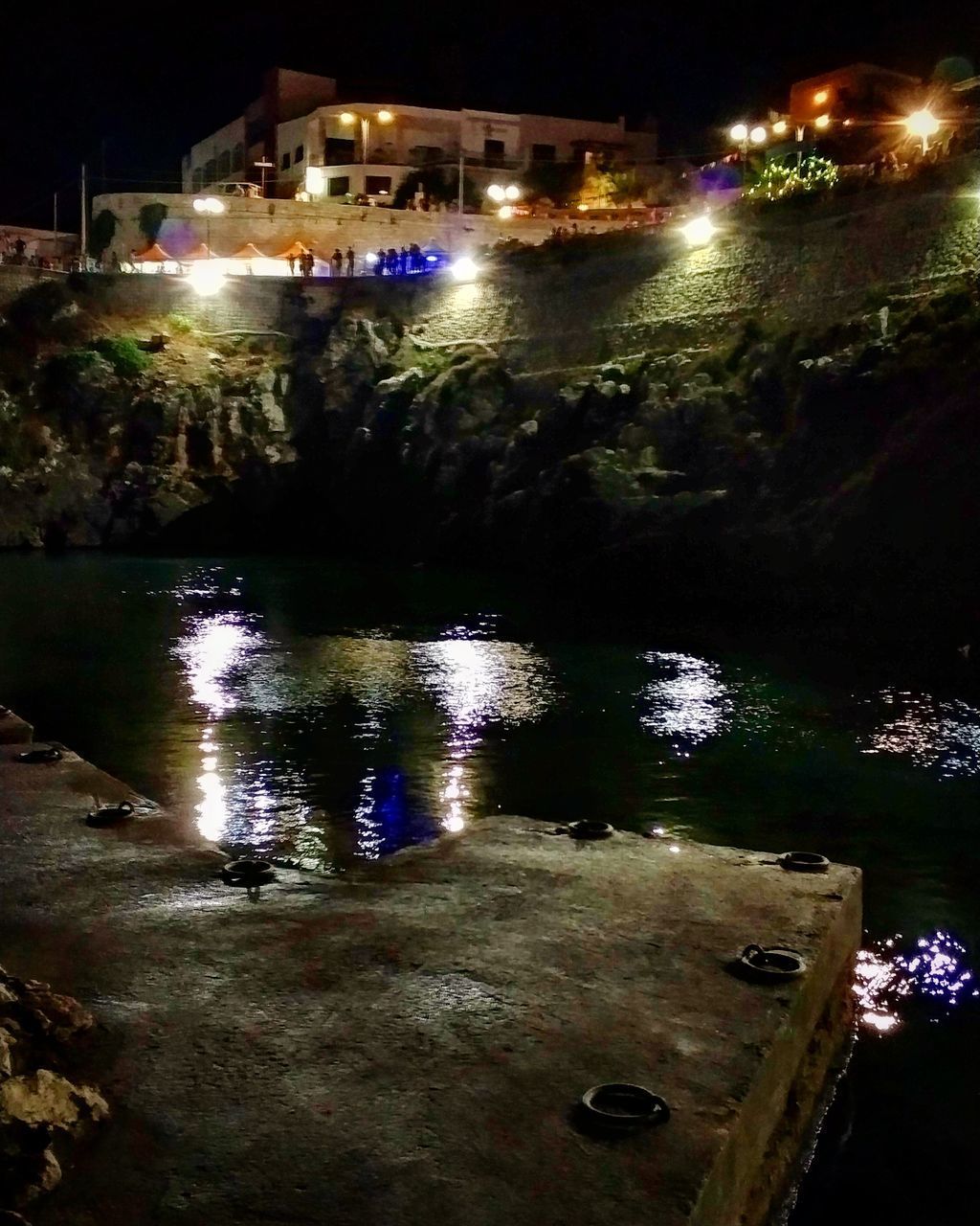 REFLECTION OF ILLUMINATED BUILDINGS IN WATER