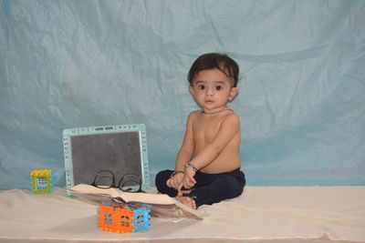 Portrait of boy sitting on table