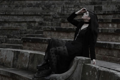 Woman sitting on staircase