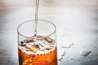 Close-up of wet glass on table