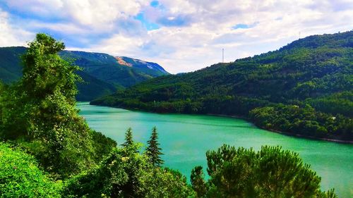 Scenic view of lake and mountains against sky