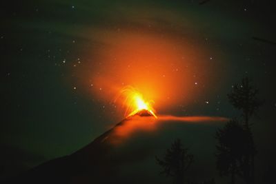 Scenic view of silhouette mountain against sky at night