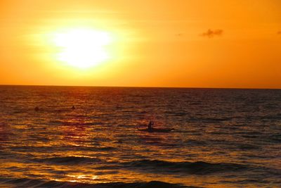 Scenic view of sea against orange sky