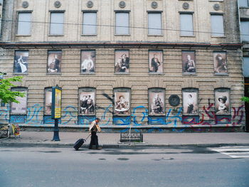 Graffiti on building by street in city