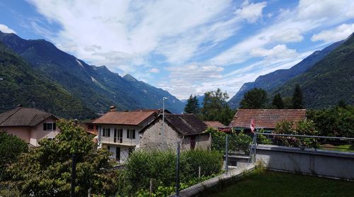 Houses by mountains against sky