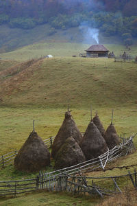 Scenic view of field and houses against sky