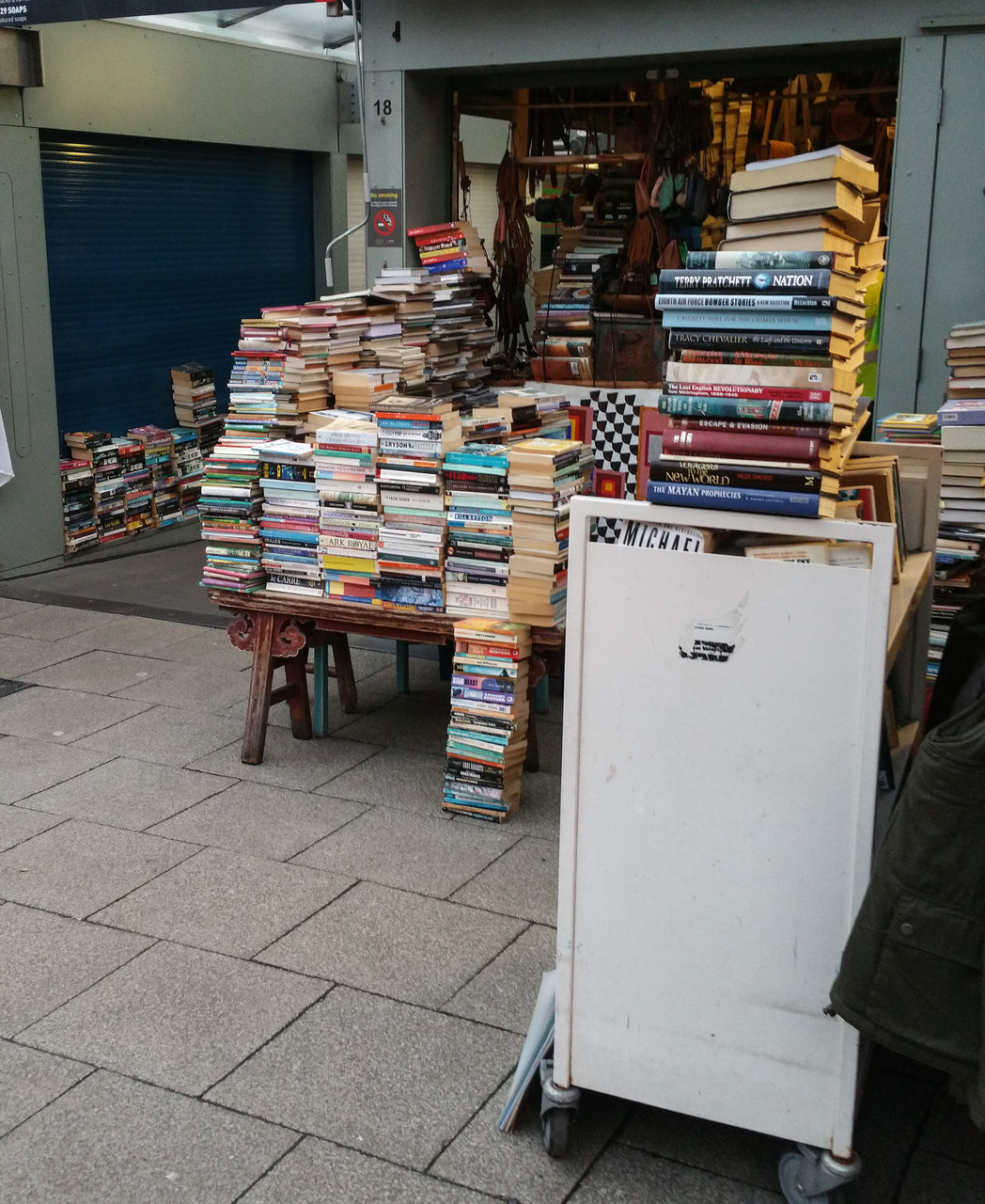 STACK OF BOOKS IN STORE FOR SALE AT MARKET