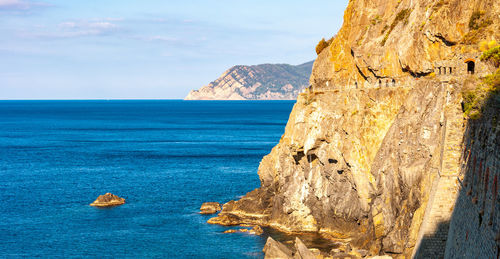 Scenic view of rock formation in sea against sky