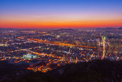 High angle view of illuminated buildings at night