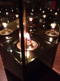 Lit candle in dark room