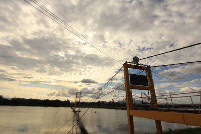 Low angle view of bridge over river against sky