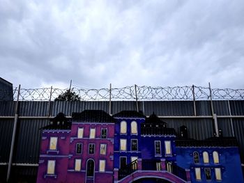 Low angle view of building against cloudy sky