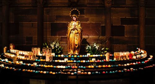 Statue of illuminated temple against building