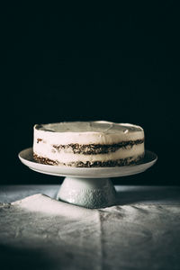 Close-up of cake against black background