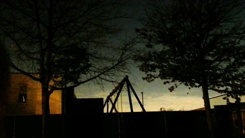 Low angle view of bare trees against the sky