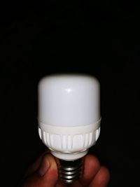 Close-up of hand holding light bulb