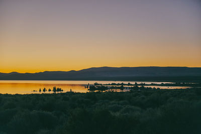 Scenic view of sea against clear sky during sunset